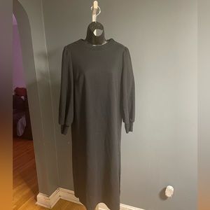 Black shirt dress. Black pucker sleeve. Slit on both sides